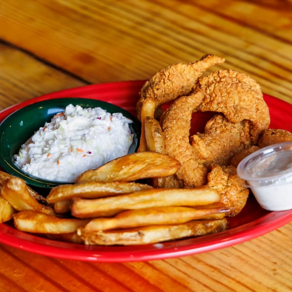 Big B Barbecue's fried chicken tenders and fries with coleslaw and dipping sauce on a red plate.